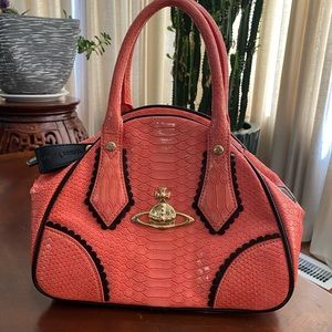 Authentic, gently loved, Viviane Westwood salmon colored purse.